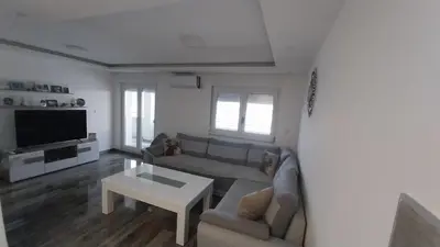 a living room with a couch and a table at Luka Opal in Doboj