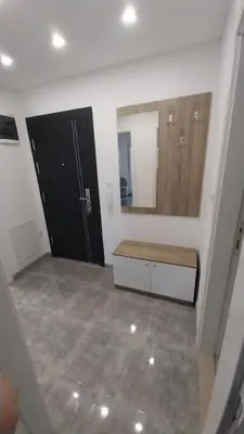 a bathroom with a black door and a mirror at Luka Opal in Doboj