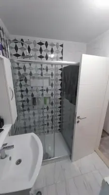 a bathroom with a shower and a sink at Luka Opal in Doboj
