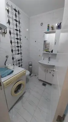 a white bathroom with a toilet and a sink at Luka Opal in Doboj