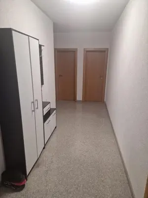 an empty room with a dresser and a cabinet and doors at APARTMAN Iva in Tomislavgrad