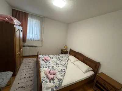 a bedroom with a bed with two stuffed animals on it at APARTMAN Iva in Tomislavgrad