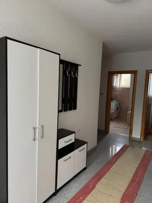 a room with a large white cabinet and a bathroom at APARTMAN Iva in Tomislavgrad