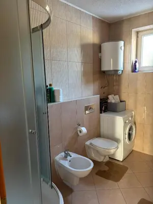 a bathroom with a toilet and a sink at APARTMAN Iva in Tomislavgrad