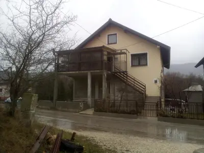 a house with a balcony on the side of it at apartman SM IK 5 in Šujica