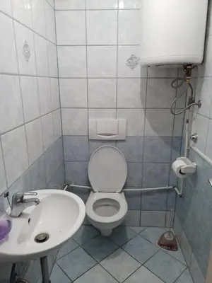 a bathroom with a toilet and a sink at apartman SM IK 5 in Šujica