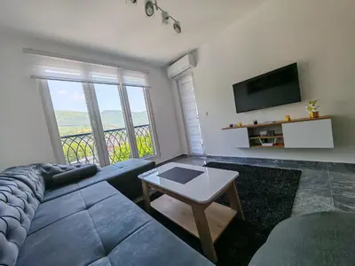 a living room with a couch and a tv at Apartman Nermin in Travnik