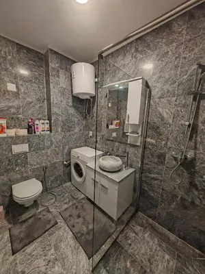 a bathroom with a shower stall and a toilet at Apartman Nermin in Travnik