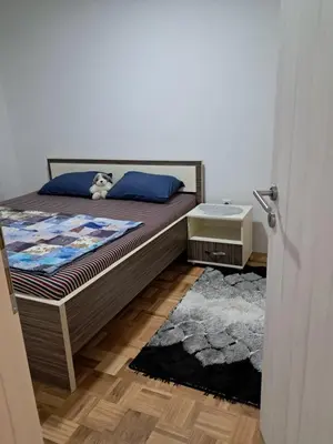 a bedroom with a bed with a teddy bear on it at Apartmani Jaca in Tuzla