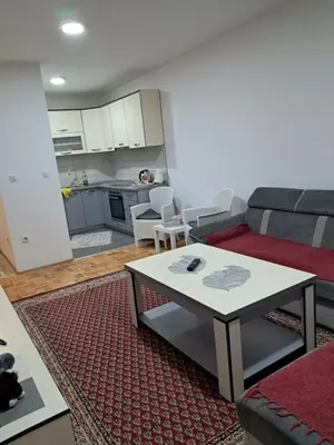 a living room with a couch and a table at Apartmani Jaca in Tuzla