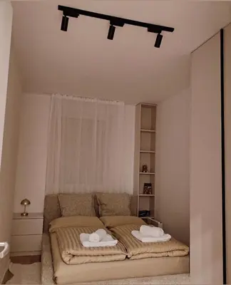 a bedroom with a bed with two towels on it at Apartment Feel Banja Luka in Banja Luka