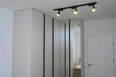 a room with white walls and mirrors and a closet at Apartment Feel Banja Luka in Banja Luka