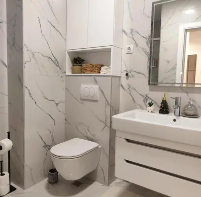 a white bathroom with a toilet and a sink at Apartment Feel Banja Luka in Banja Luka