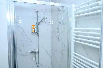 a bathroom with a shower with a glass door at Apartment Feel Banja Luka in Banja Luka
