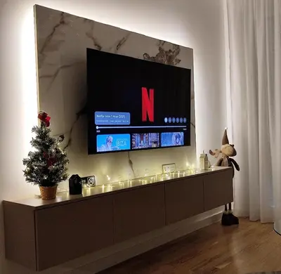 a living room with a television and a christmas tree at Apartment Feel Banja Luka in Banja Luka
