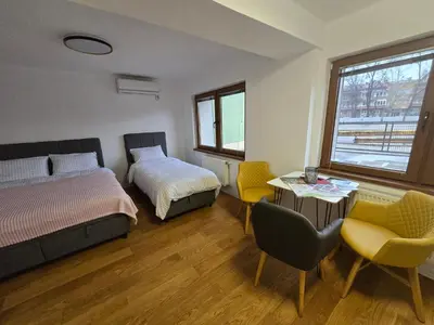 a bedroom with a bed and a table and chairs at Plavi most in Tuzla