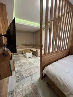 a bedroom with a bed and a flat screen tv at Crown Apartmani Vlašić in Vlasic