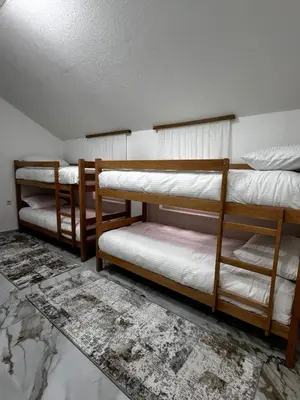a room with three bunk beds in a room at Crown Apartmani Vlašić in Vlasic