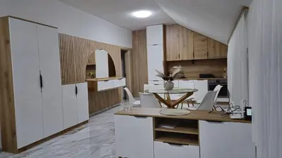 a kitchen and dining room with a table and chairs at Crown Apartmani Vlašić in Vlasic