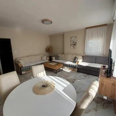 a living room with a table and a couch at Crown Apartmani Vlašić in Vlasic