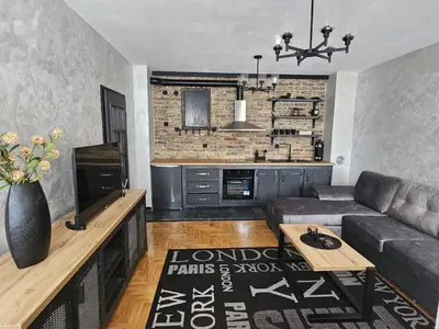 a living room with a couch and a table at Industry in Banja Luka