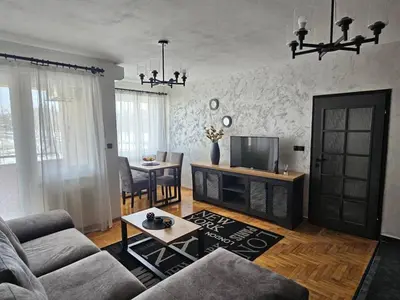a living room with a couch and a tv at Industry in Banja Luka