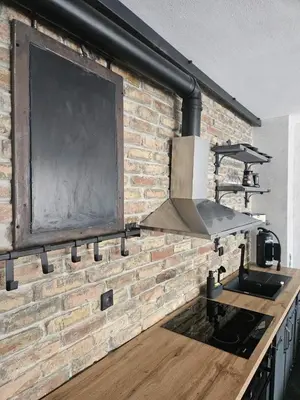 a kitchen with a brick wall and a sink at Industry in Banja Luka