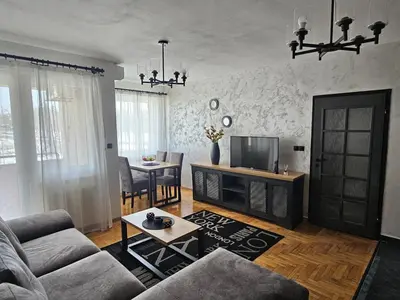 a living room with a couch and a tv at Industry in Banja Luka
