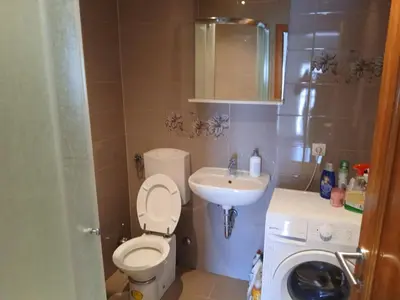 a small bathroom with a toilet and a sink at Apartman ZM in Livno