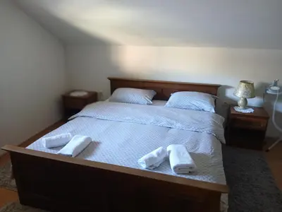 a bedroom with a bed with two towels on it at Apartman ZM in Livno