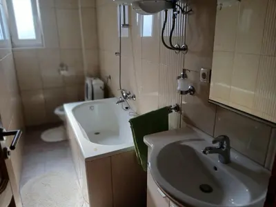 a bathroom with a sink and a bath tub at Apartman ZM in Livno