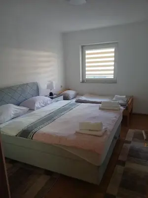 a bedroom with two beds and a window at Apartman ZM in Livno