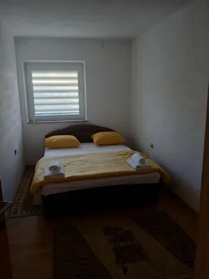 a bed in a room with a window at Apartman ZM in Livno