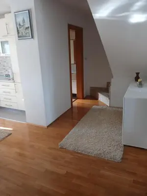 a living room with a staircase and a rug at Apartman ZM in Livno