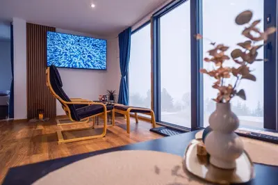 a living room with a table and a chair at Container House Kod Čupe in Kupres