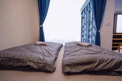 two beds in a bedroom with a window at Container House Kod Čupe in Kupres