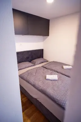 a bedroom with a bed with two towels on it at Container House Kod Čupe in Kupres