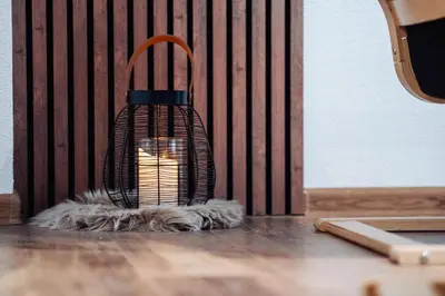 a candle in a cage sitting on a table at Container House Kod Čupe in Kupres