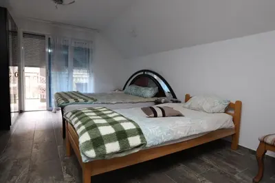 two beds sitting in a room with at Villa Mali Vuk in Banja Luka