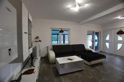 a living room with a couch and a table at Villa Mali Vuk in Banja Luka