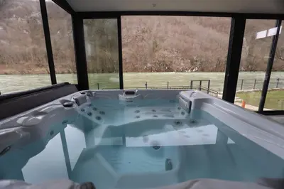 a hot tub with a view of the water at Villa Mali Vuk in Banja Luka
