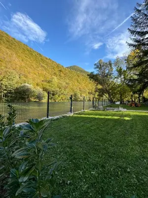 a park with a fence and a hill at Villa Mali Vuk in Banja Luka