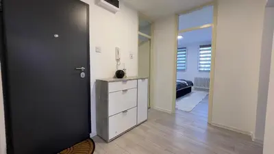a room with a black door and a white cabinet at HomeSpot Banja Luka in Banja Luka