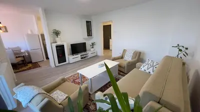 a living room with a couch and a tv at HomeSpot Banja Luka in Banja Luka