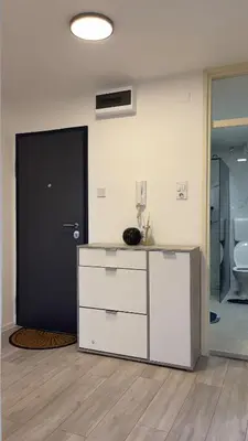 a room with a white dresser and a black door at HomeSpot Banja Luka in Banja Luka