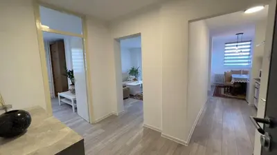 an empty room with a hallway with a living room at HomeSpot Banja Luka in Banja Luka