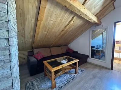 a living room with a couch and a table at Apartman Santro in Kupres