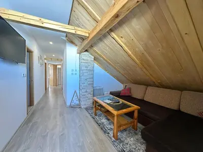 a living room with a couch and a table at Apartman Santro in Kupres