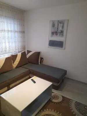 a living room with a couch and a table at Palma Apartman in Tuzla