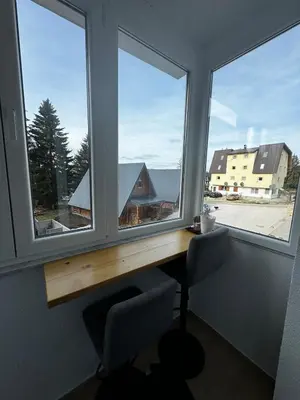 an office with two windows and a desk with a chair at Winter Nights Vlasic in Vlasic